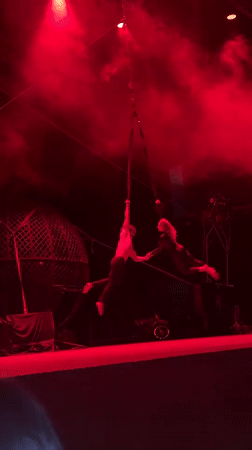 Aerial rope act unfolds under red lights in Tangier