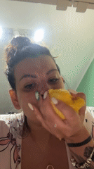 Woman enjoys late-night mango snack in Plovdiv apartment