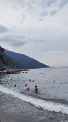 Busy summer afternoon on Camogli's pebble beach, Liguria