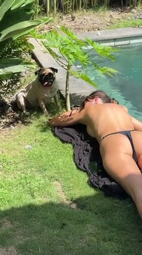 Women enjoy early morning poolside leisure time in Mengwi