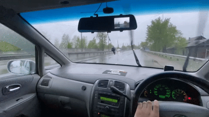 Driver uses wipers during rainy evening drive in Irkutsk