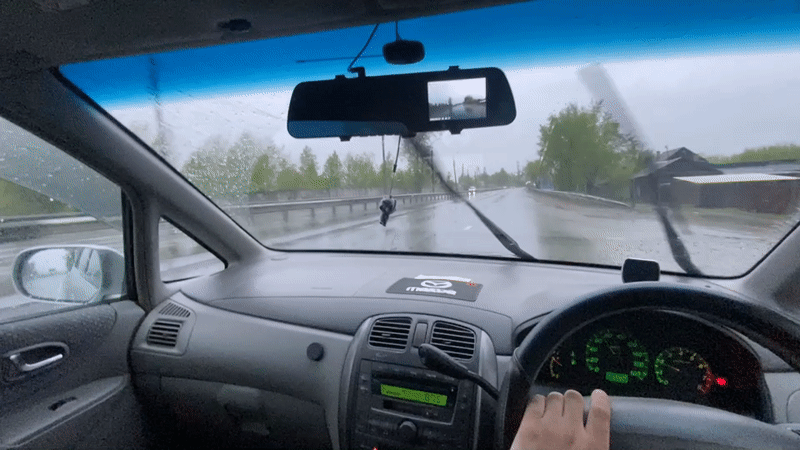 Driver uses wipers during rainy evening drive in Irkutsk