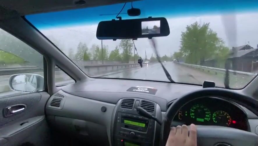 Driver uses wipers during rainy evening drive in Irkutsk
