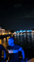 Nighttime gathering captured along Paris riverfront