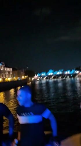 Nighttime gathering captured along Paris riverfront