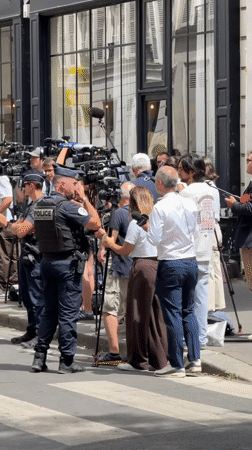 Heavy security and press outside a Paris building entrance