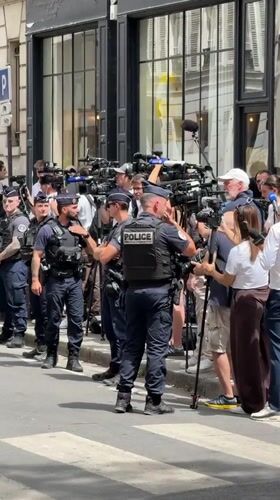Heavy security and press outside a Paris building entrance