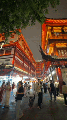 Shanghai's Yuyuan Garden bustles with nighttime crowds under ornate lights