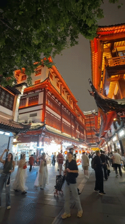 Shanghai's Yuyuan Garden bustles with nighttime crowds under ornate lights