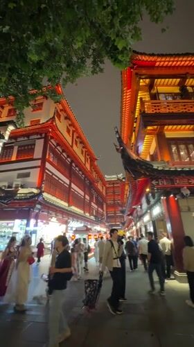 Shanghai's Yuyuan Garden bustles with nighttime crowds under ornate lights