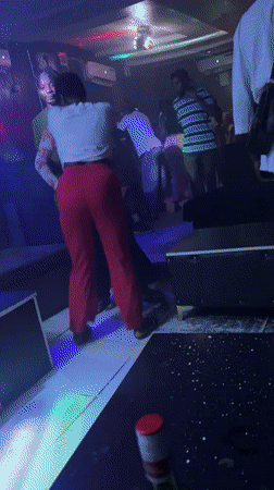 Nightclub patrons dance under disco lights in Guzape, Nigeria