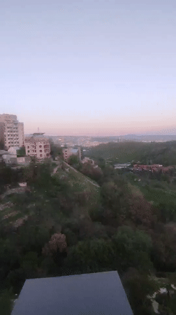 Dawn cityscape captured over green hills of Yerevan, Armenia