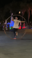 Hoop performer draws a crowd at night in Alanya
