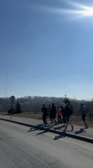 Morning joggers spotted on Kazan sidewalk during sunny weather