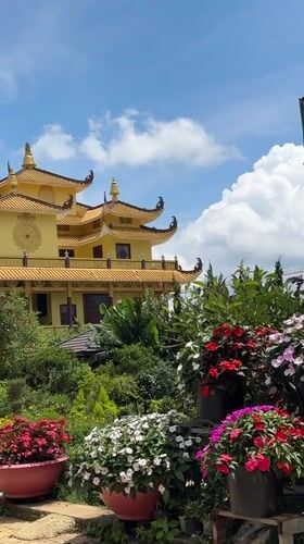 Traditional yellow pagoda captured amid gardens in Da Lat