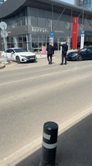 Two suited men observed near cars outside Sofia Ferrari dealership