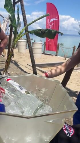 Woman with vodka Red Bull bucket at Greek beach bar