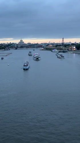 Passenger boats on a city river from dusk to night
