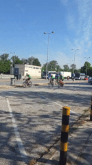 Five cyclists in green ride through Greek town