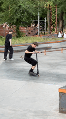 Skatepark session with scooters, skateboards, and spectators