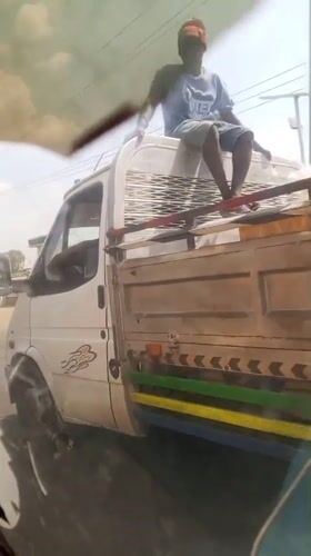 Nigerian roadside scenes: truck rider and fruit vendor captured