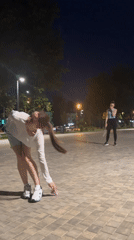 Badminton under the lamplights in a Moscow plaza at night