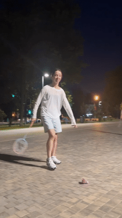 Badminton under the lamplights in a Moscow plaza at night