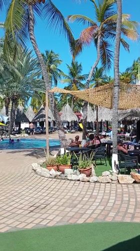 Resort guests enjoy poolside activities in Porlamar, Venezuela