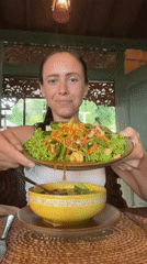 Woman enjoys traditional Indonesian meal at local restaurant