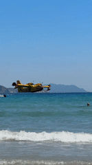 Firefighting plane drops water over crowded La Ciotat beach
