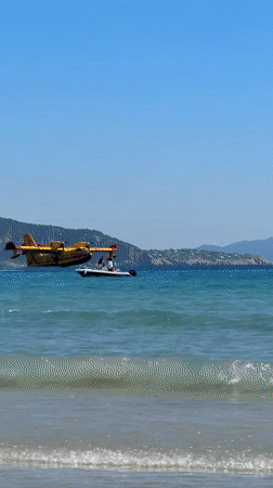 Firefighting plane drops water over crowded La Ciotat beach