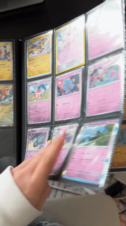 Pokémon card collector organizes binder in Milan