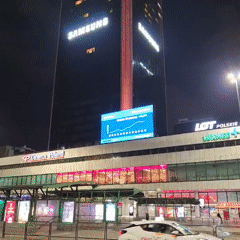 Nighttime urban scenes documented across central Warsaw during evening rush