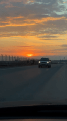 Car travels Russian highway during sunset near Chaikovsky
