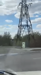 Electrical transmission tower filmed from vehicle in Kharkiv