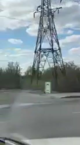 Electrical transmission tower filmed from vehicle in Kharkiv