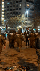 Riot police deploy in formation on Providencia street