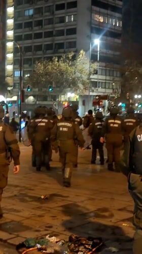 Riot police deploy in formation on Providencia street