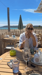 Woman enjoys beachside dining experience in Ramatuelle, France