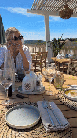 Woman enjoys beachside dining experience in Ramatuelle, France