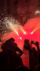 Dragon effigy and fireworks light up a Barcelona street celebration