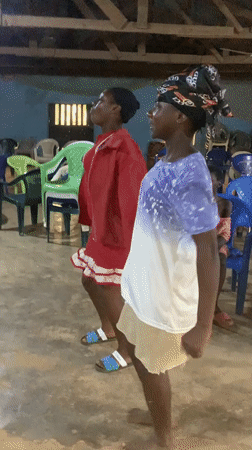 Two women dance indoors in Fada, Nigeria