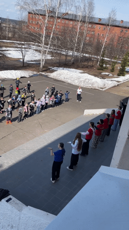 Children's outdoor dance activity documented in Sarapul schoolyard