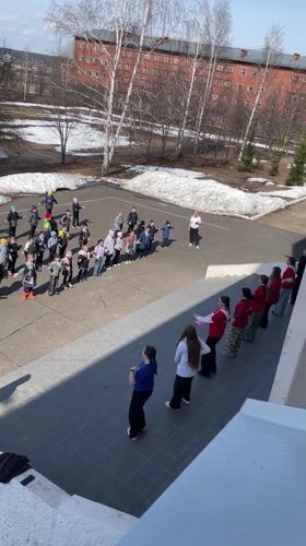 Children's outdoor dance activity documented in Sarapul schoolyard