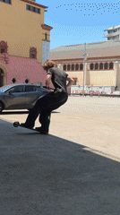 Young man performs scooter tricks in Barcelona street