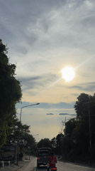 Sunny ocean vista filmed from roadway in Ban Haad Rin