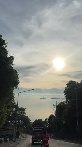 Sunny ocean vista filmed from roadway in Ban Haad Rin