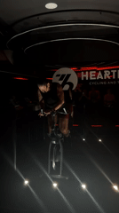 Fitness enthusiast pedals energetically during cycling class in Puebla studio