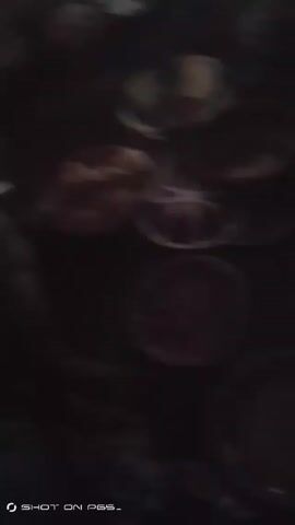 The video shows a dark and blurry overhead shot of several small dishes filled with what appears to be food. It is difficult to discern the exact type of food due to the low light and poor focus. There's also a partial view of what could be a person or piece of furniture in the lower left corner. The video is shaky, and the objects are not easily identifiable. The words "SHOT ON PES_" are visible in the bottom left corner of the screen.