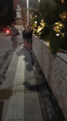 Night street food scene on a Kuta sidewalk